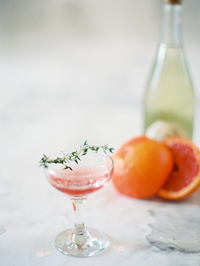 signature blood orange cocktail in martini glass