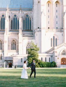 bride and groom walking outside the washington national cathedral