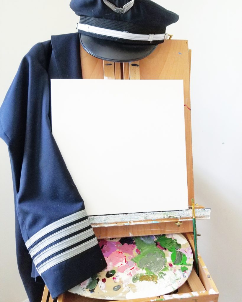 a pilot captain's jacket draped over an artist's easel