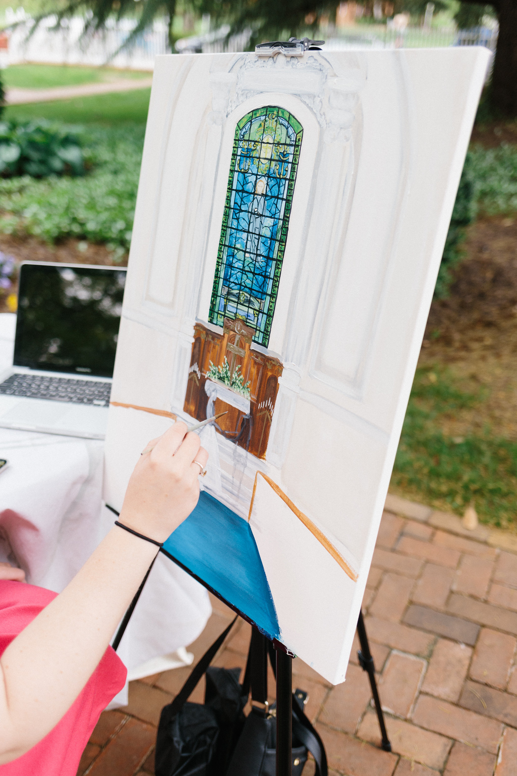 Live painter Brittany Branson painting a likeness of the bride and groom at a wedding in Annapolis