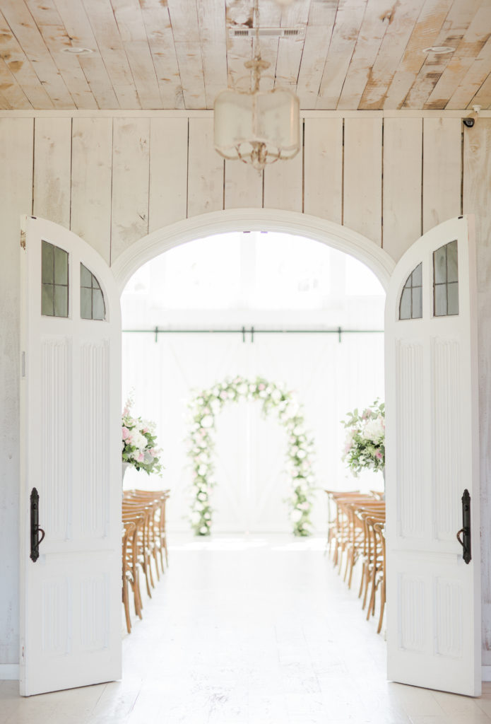 Looking through the double doors down the aisle at the White Sparrow Barn
