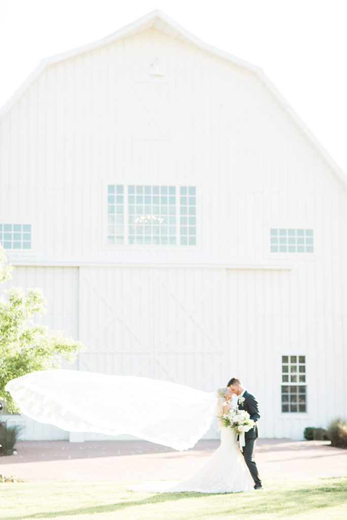 the bride and groom outside the White Sparrow Barn
