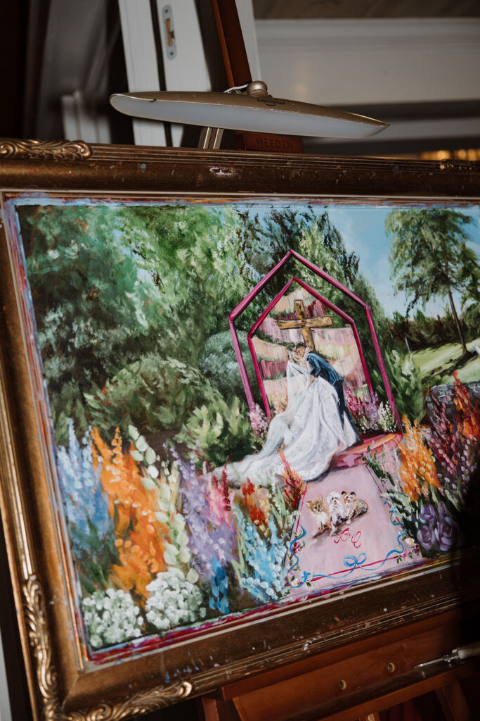A close up shot of Brittany's wedding painting that highlights Baylen and Colin's three dogs.