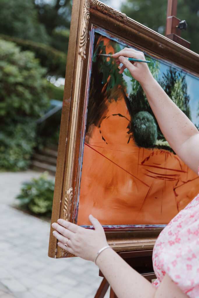 A close-up shot of the beginnings of Brittany's painting of Baylen and Colin's wedding.